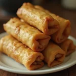 a plate of fried spring rolls